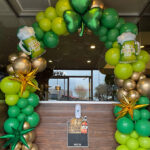 green and gold balloon arch