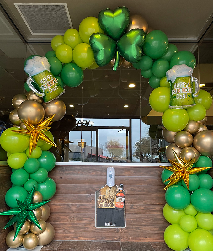 green and gold balloon arch